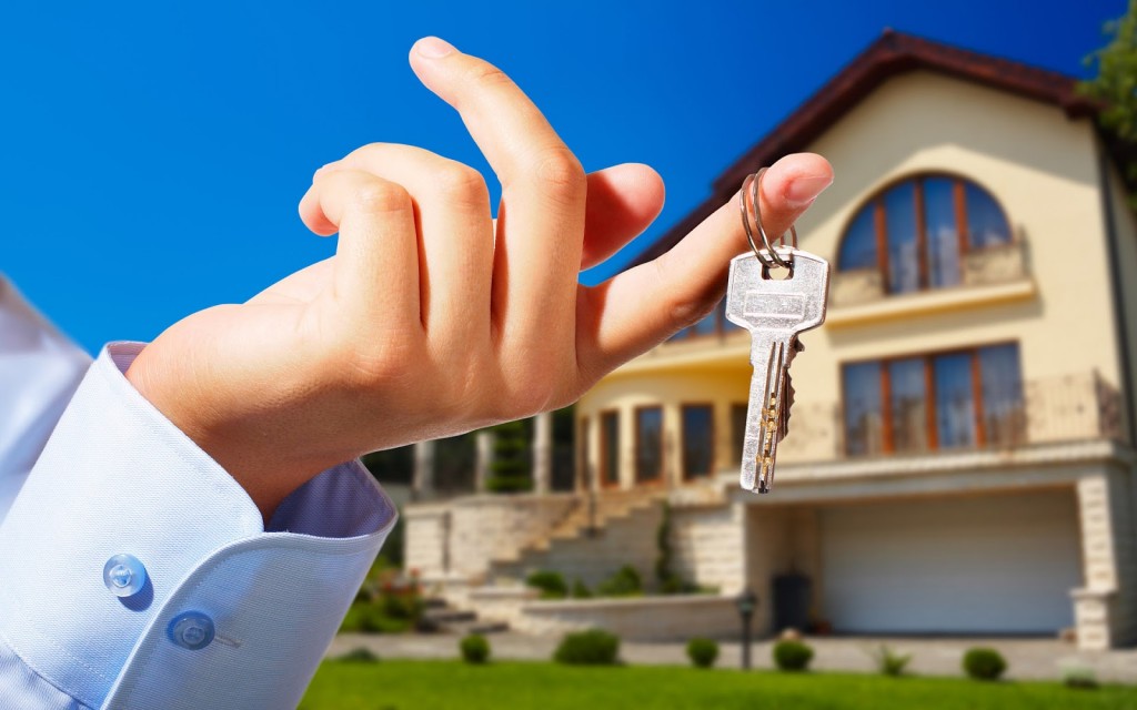 House owner/real estate agent giving away the keys - house out of focus